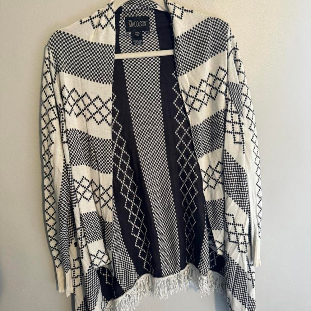 white and black geometric patterned cardigan with fringe